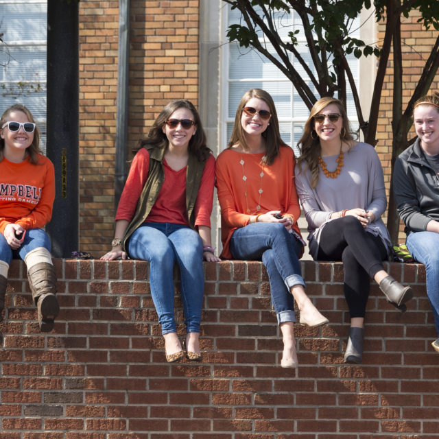 image of students sitting on wall