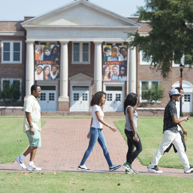 image of students walking in front of d rich