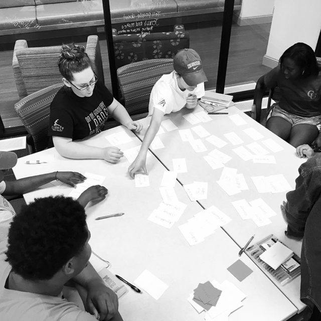 Students work at table with notecards