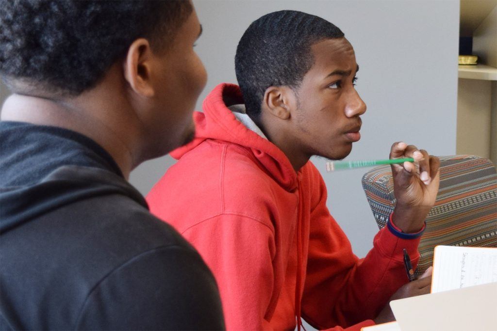 Two male students participate in a classroom session