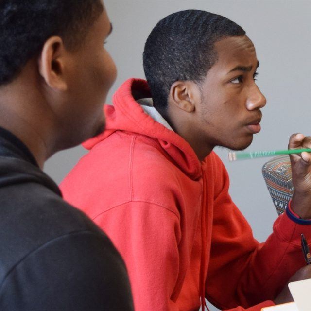 Two male students participate in a classroom session