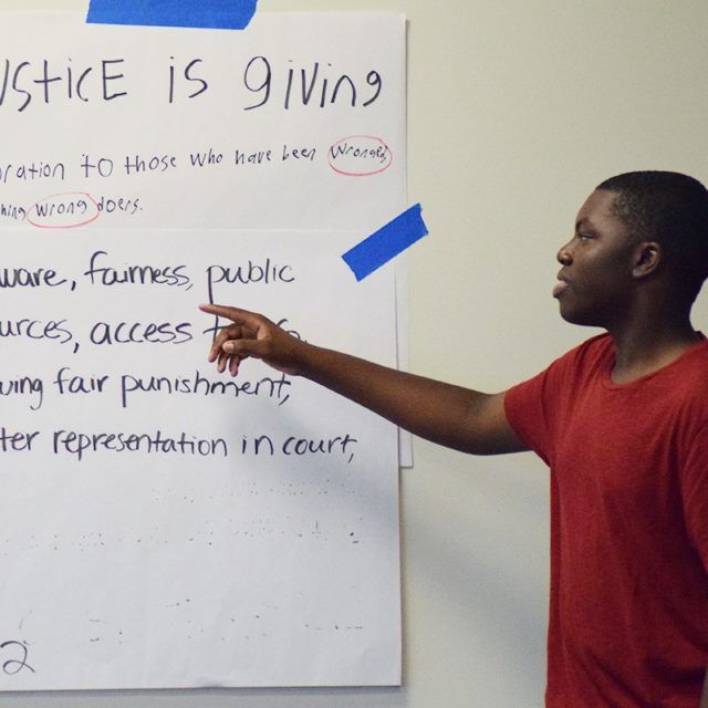 Boy explains insights from poster