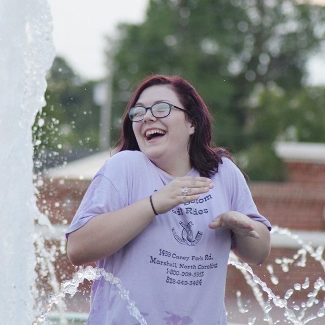 Girl laughs near fountain