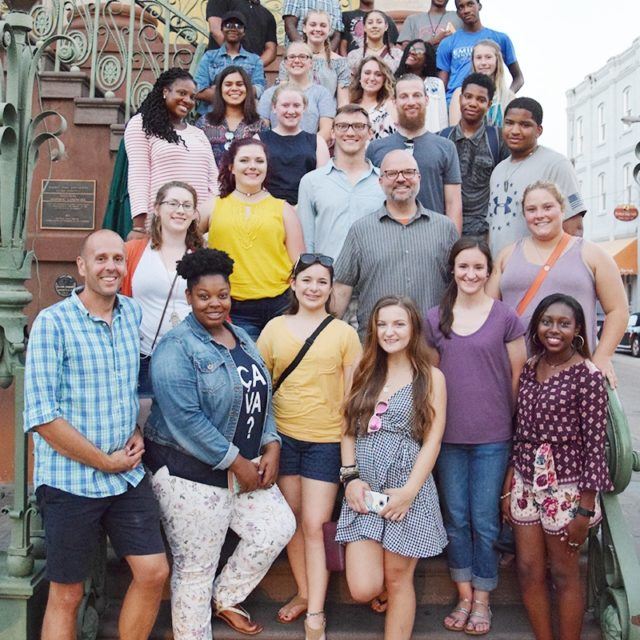 Students and faculty from the CYTI pose on a staircase