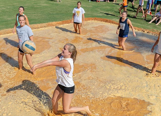 Students play mud volleyball during Welcome Week.