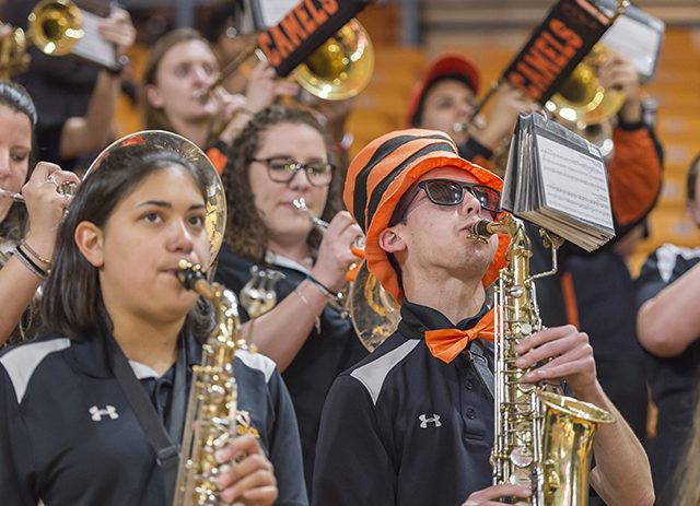 Members of the band perform during a basketball game.