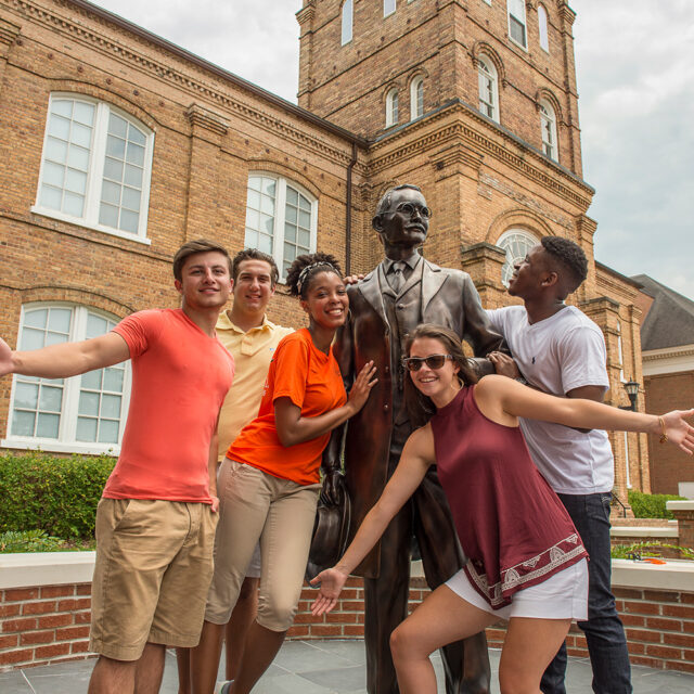 image of students in front of JA Campbell Statue at Kivett