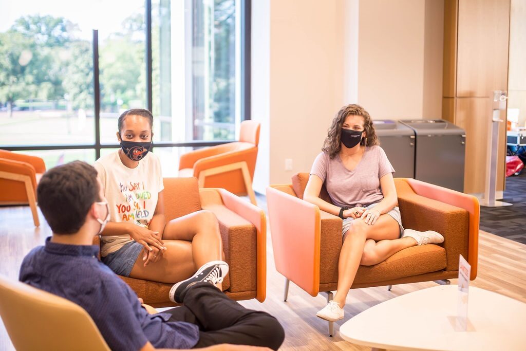 Image of students gathering for a conversation inside the Student Union