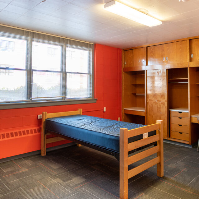 Interior of Powell Hall including a twin bed in front of a large window.