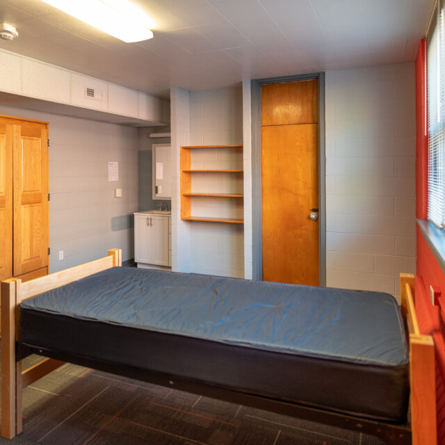 Interior of Powell Hall including a twin bed and wardrobe.