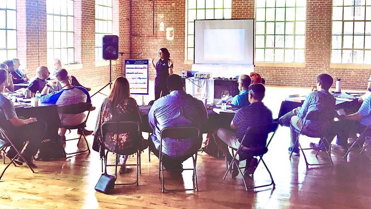 Image of a group gathered to listen to a speaker