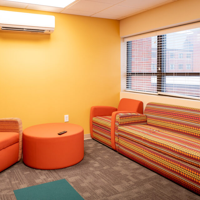 Image of a Jones Hall lounge featuring a comfortable chair and sofa.