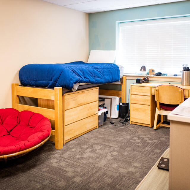 Image of a Jones Hall bedroom including a twin bed and desk