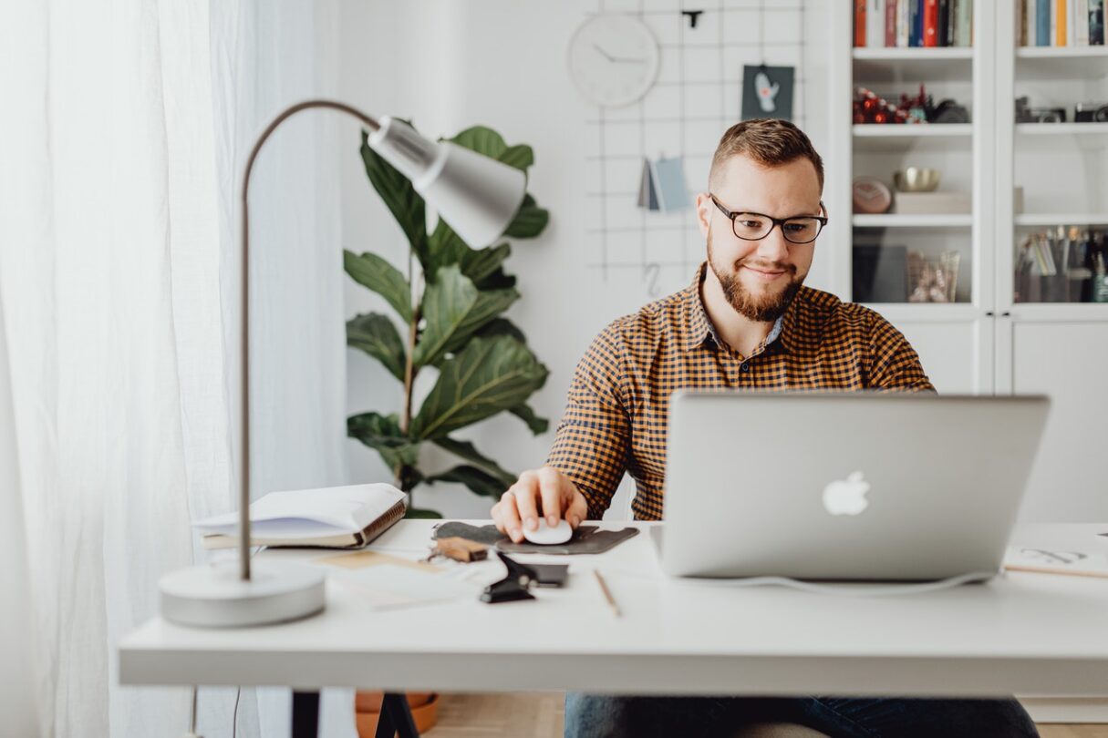 A male students works on an assignment from his home office.