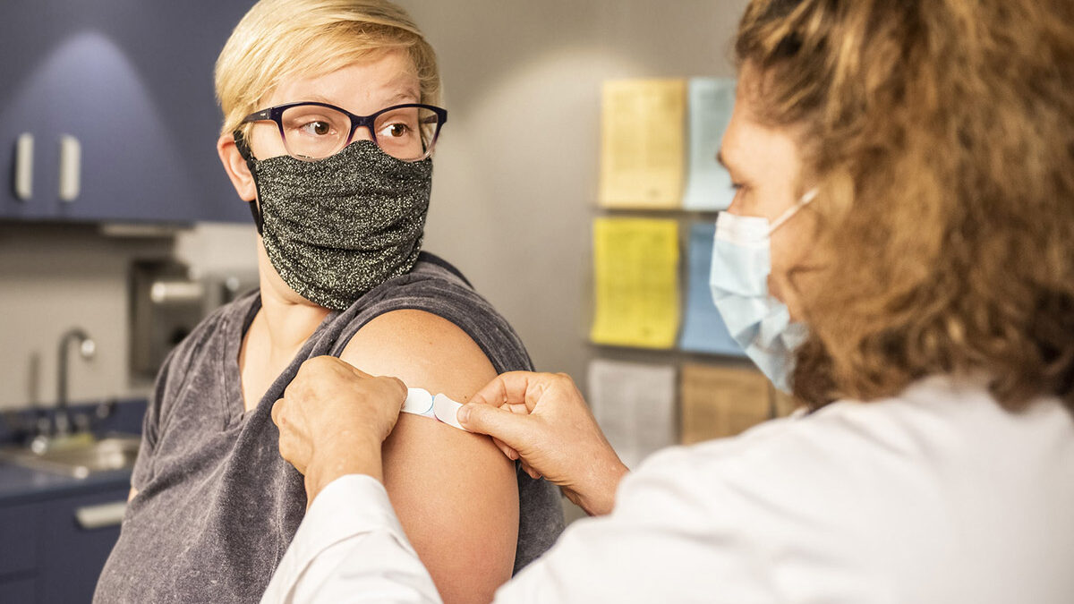 image of a person getting bandage after an injection