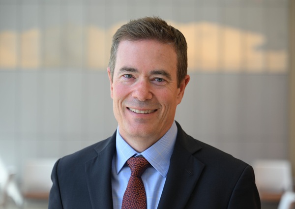 headshot of Adam English