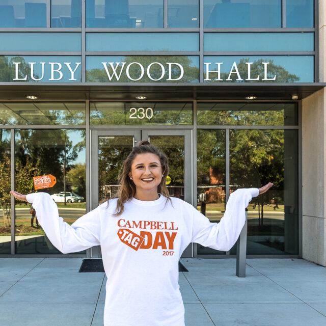 student outside of Luby Wood Hall