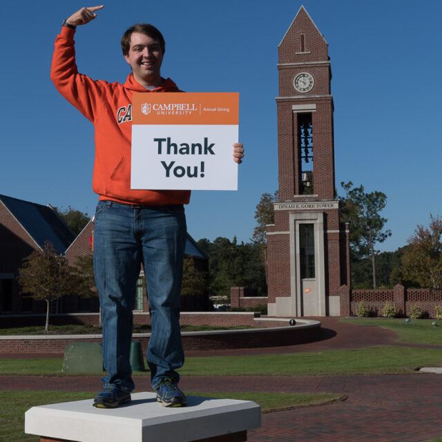 image of a student holding a thank you card