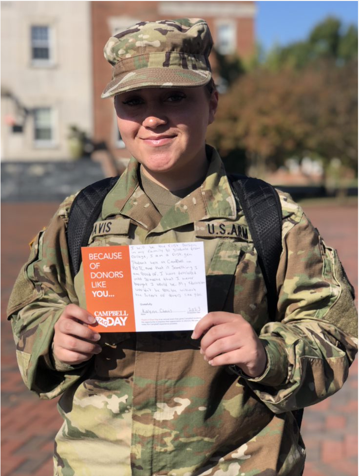 U.S. Army recruit holds thank you letter on TAG day