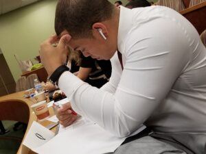 Photo of one of the student competitors staring intently at a document.