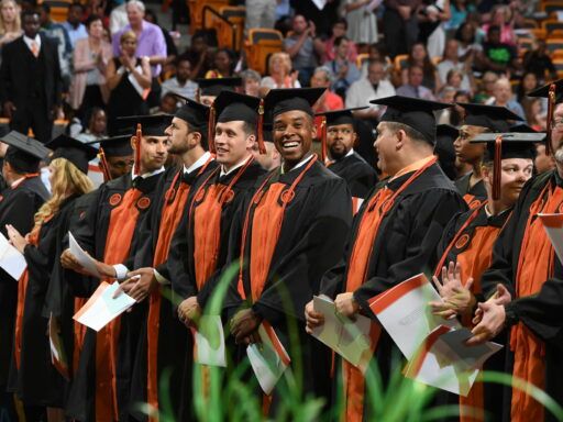 adult and online graduates in line in Gore Arena