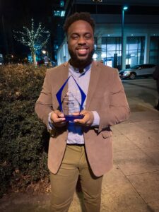 Photo of Daniel Nelson '21 holding best advocate award