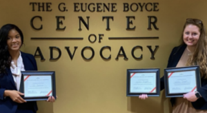 Photo of Old Kivett winners Tia Overway and Wallace Driggers in front of Gene Boyce Advocacy Center