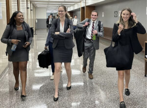 Photo of Campbell Law advocates walking down hallway in LA Courthouse