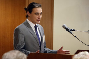 Photo of Cory Goss '23 speaking at podium.