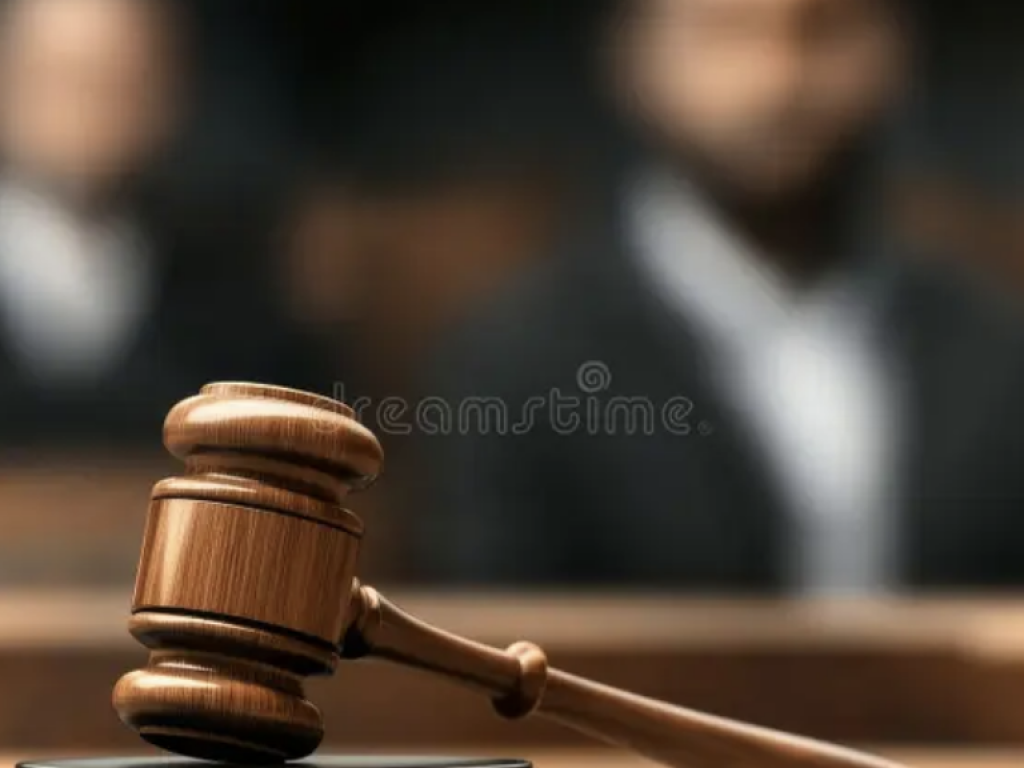Photo of gavel with blurry people in background