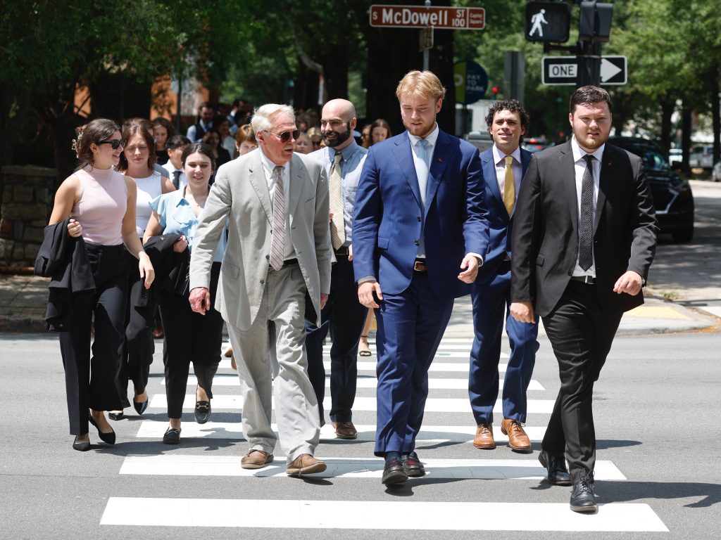 Photo of Dean Leonard leading students on court crawl