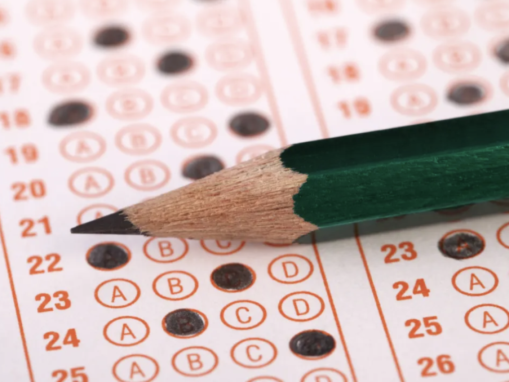 Photo of a pencil on an exam form with dots filled in