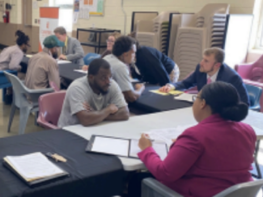 Photo from Blanchard Community Law Clinic's Driver's License Restoration event at Sampson Correctional Facility showing folks filling out paperwork