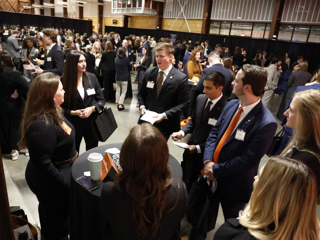 Photo of students talking to potential employers at 2025 Career Night at Raleigh Union Station
