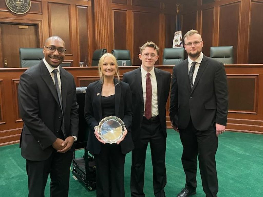 Photo of 2025 NYC Bar Regional Moot Court Champions Jessica Griffin ‘26, Christian Ray ‘26 and Justin Booker ‘26 with Coach Justin Lockett ‘22