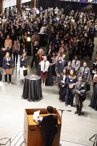 Photo overlooking crowd of students, alumni ad employers gathered in Raleigh Union Station for 2025 Career Night in front of speaker at podium