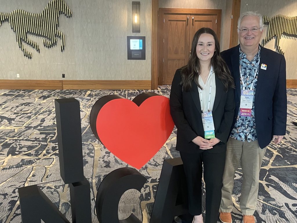 Dr. Dean Farmer and student at conference