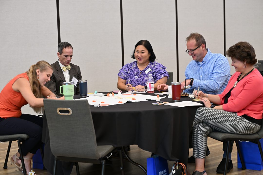 Small group collaboration at a table during conference.