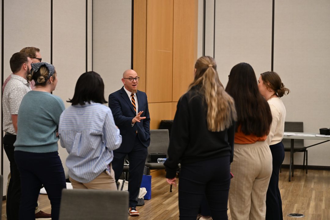 Dr. David Tillman talking with a group of students.