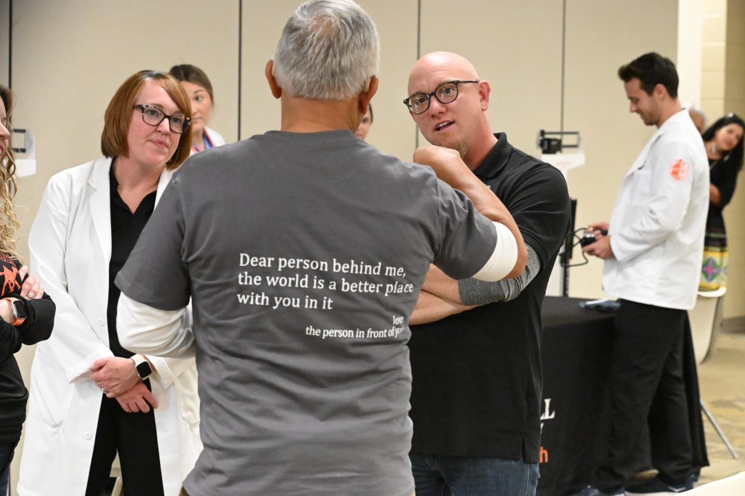 Professors talking with participant.