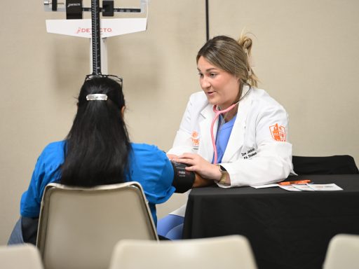PA student taking blood pressure.