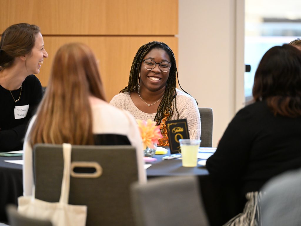 Participant smiling at table.