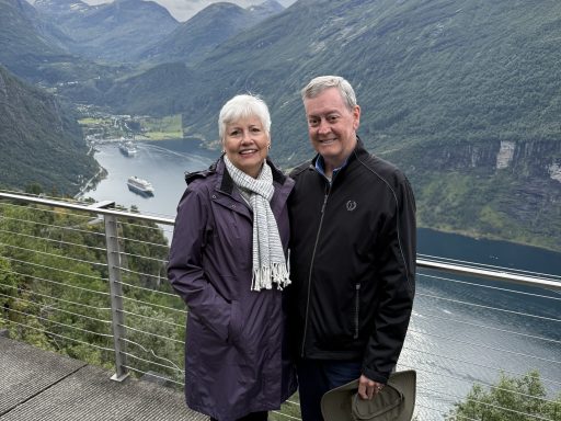 Photo of Judge Jane Gray '79 and her husband, Frank Gray, standing in front of a Norwegian Fjord.
