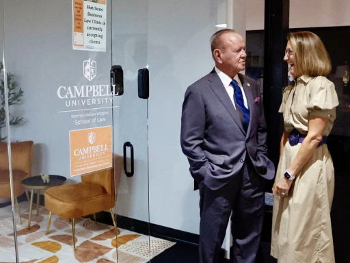 Photo of Terry Hutchens and Clinical Professor Benji Jones standing outside Hutchens Business Law Clinic in Raleigh Founded.