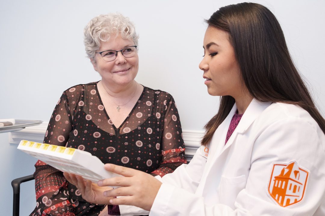 Pharmacy student counseling patient.