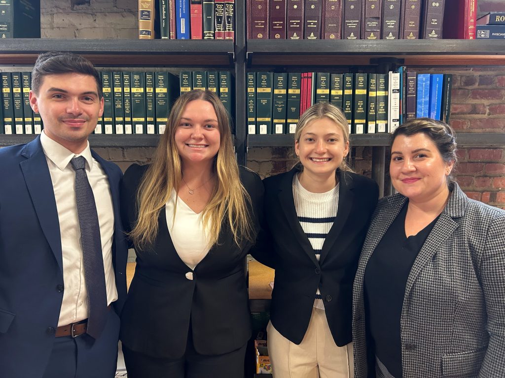 Photo of three Campbell Law students and Blanchard Community Law Clinic Professor Laura Clark