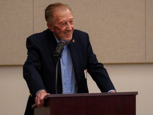 Bob Barker ('65) smiling while speaking at a podium
