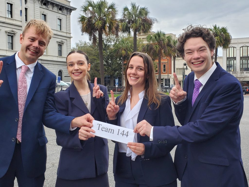 Photo of four people celebrating