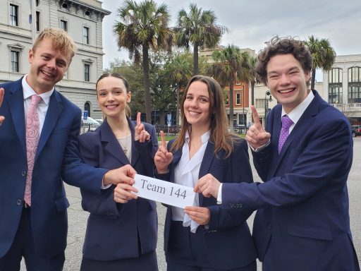 Photo of four people celebrating