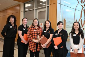 CPHS admissions team standing together in a row smiling for the camera.